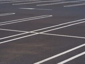 asphalt surface of car parking slot with white line stripe